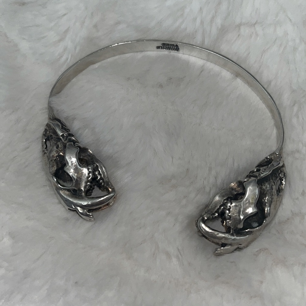 silver cuff with a skull on each end